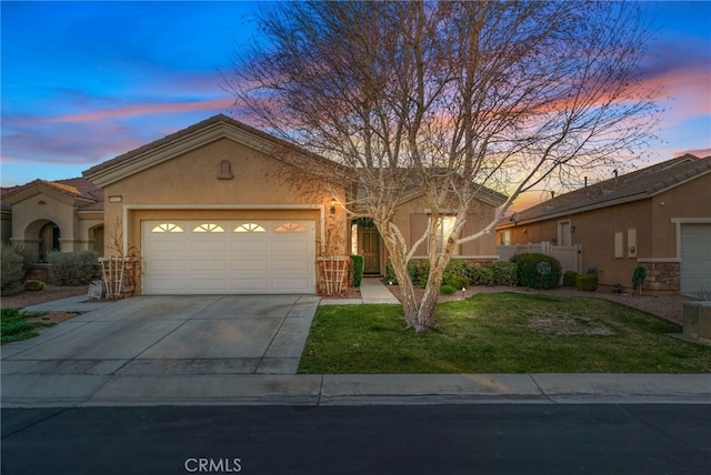 view of front of property with a yard and a garage