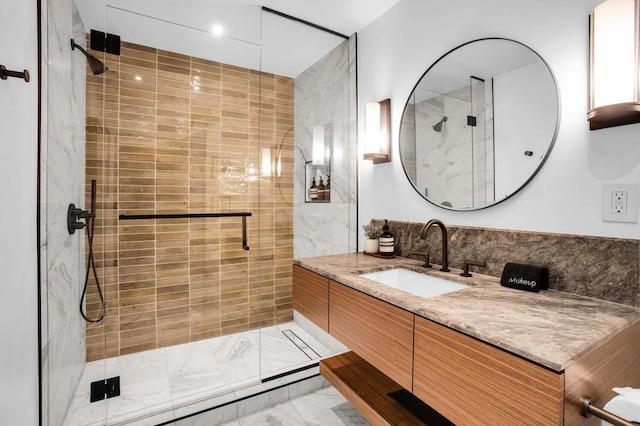 bathroom featuring vanity and a shower with door