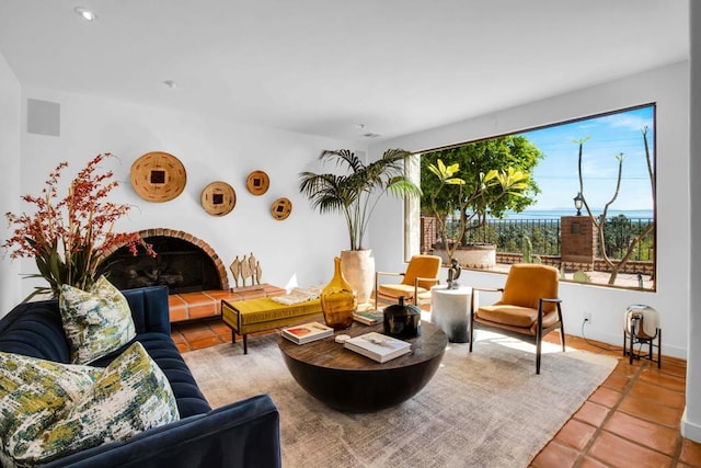 tiled living room featuring a tiled fireplace