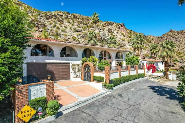 mediterranean / spanish house with a mountain view and a garage