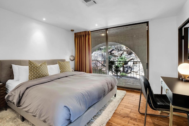 bedroom featuring access to outside and light hardwood / wood-style flooring