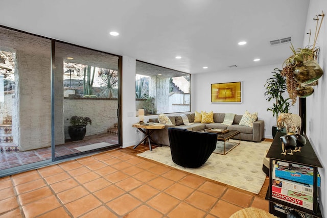 living room featuring light tile patterned flooring and plenty of natural light