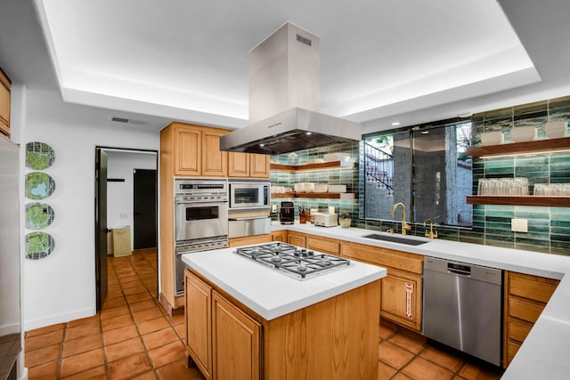 kitchen with sink, island range hood, appliances with stainless steel finishes, a center island, and decorative backsplash