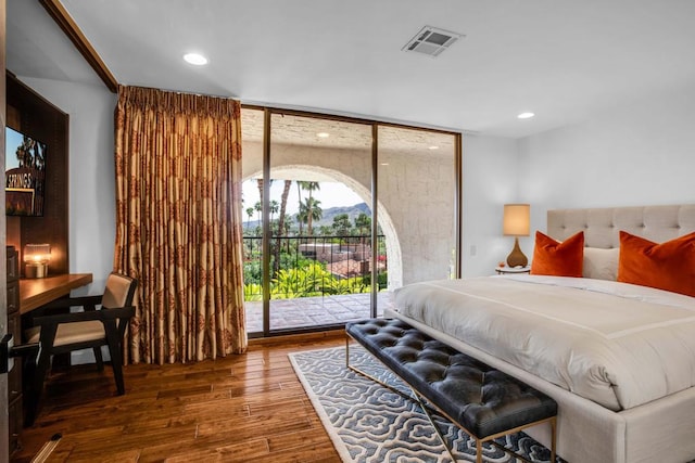 bedroom featuring hardwood / wood-style floors and access to outside