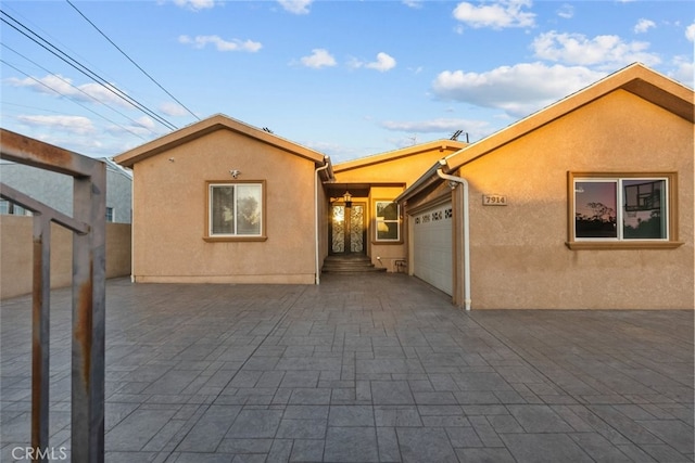 back of property with a garage