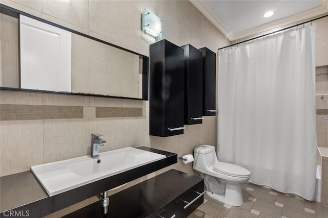 bathroom featuring ornamental molding, vanity, and toilet