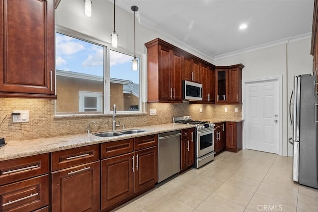 kitchen featuring appliances with stainless steel finishes, backsplash, decorative light fixtures, ornamental molding, and sink