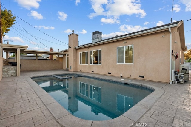 back of property with a patio and a swimming pool with hot tub