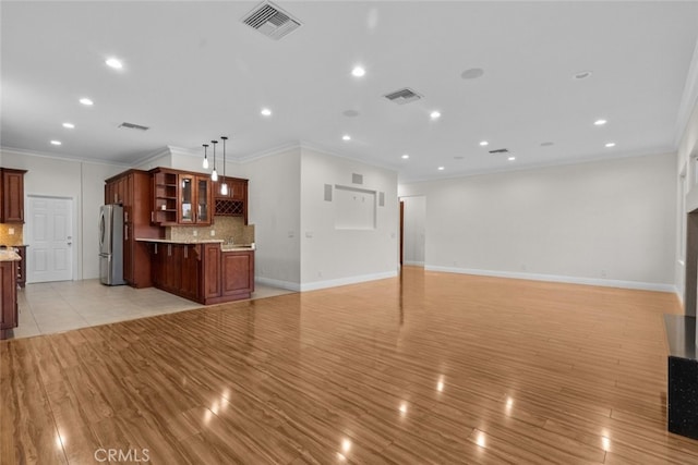 unfurnished living room with crown molding and light hardwood / wood-style flooring