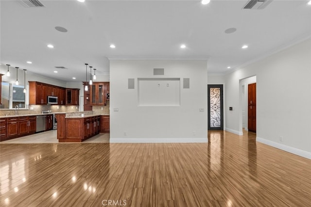 living room featuring sink, crown molding, and light hardwood / wood-style floors