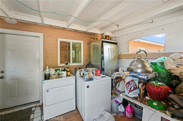 washroom with separate washer and dryer and wooden walls