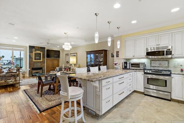 kitchen featuring white cabinets, a breakfast bar, and appliances with stainless steel finishes