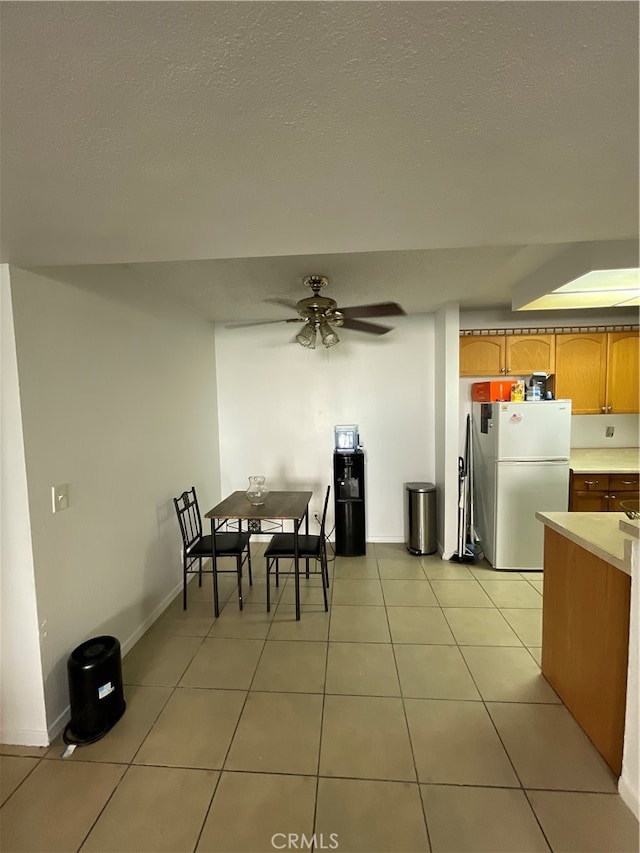 dining room featuring light tile patterned floors and ceiling fan