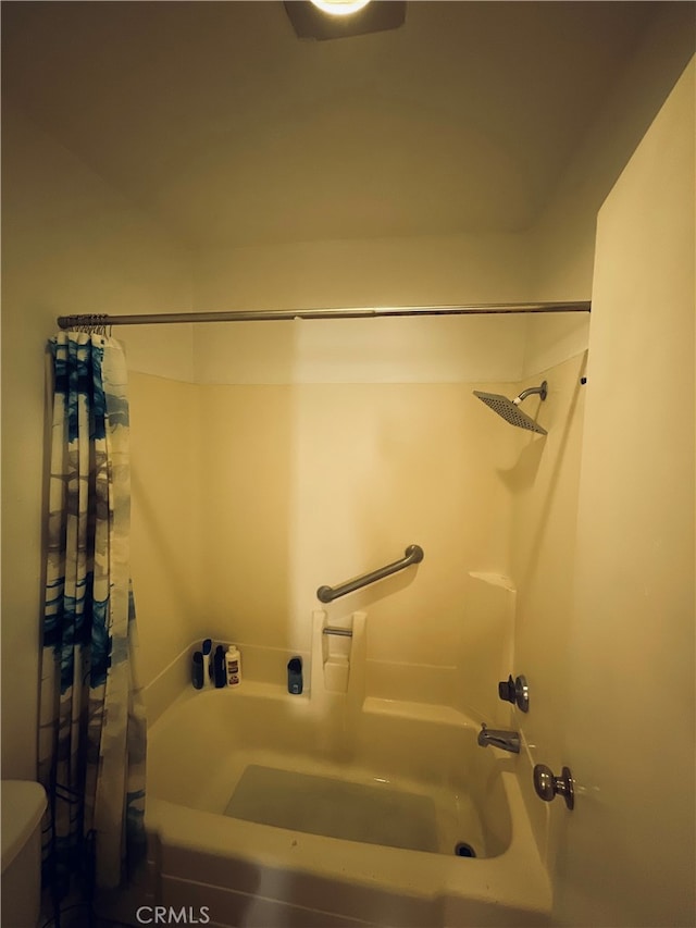 bathroom with shower / tub combo and toilet