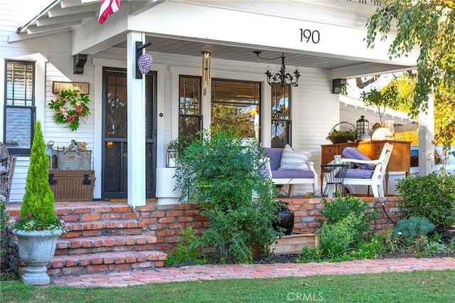 view of exterior entry with covered porch