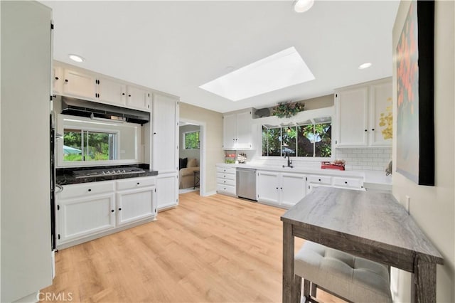 kitchen with white cabinetry and a skylight