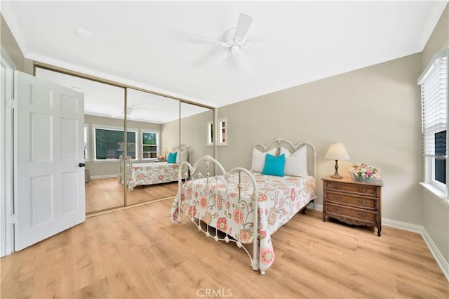 bedroom featuring ceiling fan, a closet, and hardwood / wood-style flooring