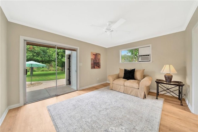 living room with ceiling fan, cooling unit, and light hardwood / wood-style flooring