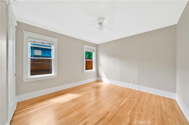 spare room with ceiling fan and light wood-type flooring