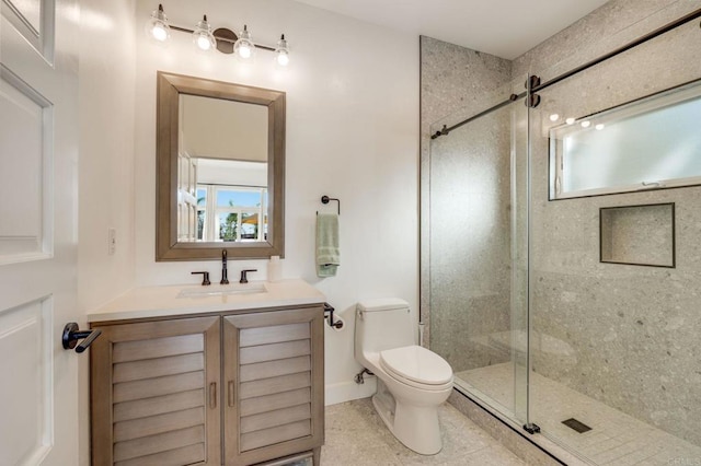 bathroom with vanity, tile patterned flooring, toilet, and walk in shower