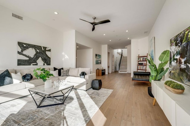 living room with light hardwood / wood-style floors and ceiling fan