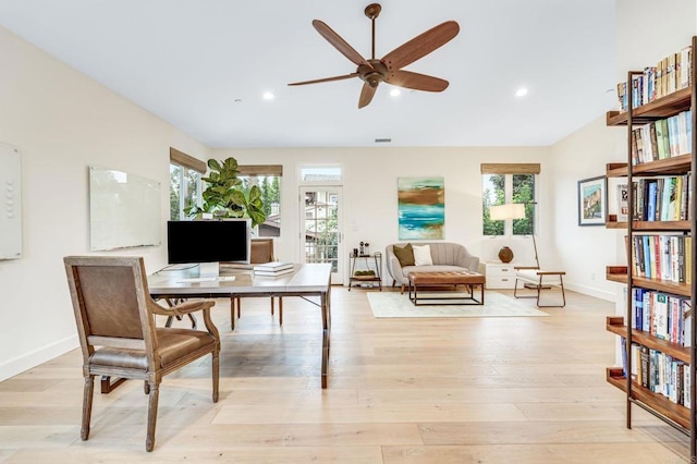 office area featuring vaulted ceiling, ceiling fan, and light hardwood / wood-style floors