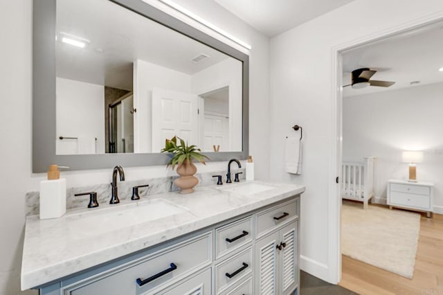 bathroom with vanity, wood-type flooring, and ceiling fan