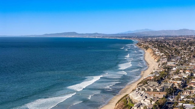 water view featuring a mountain view and a beach view