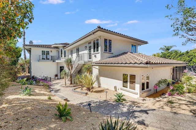 rear view of property featuring a balcony