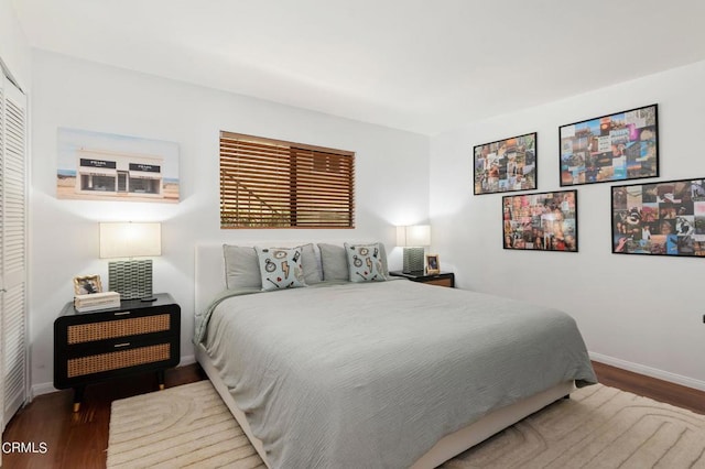 bedroom with a closet and hardwood / wood-style flooring