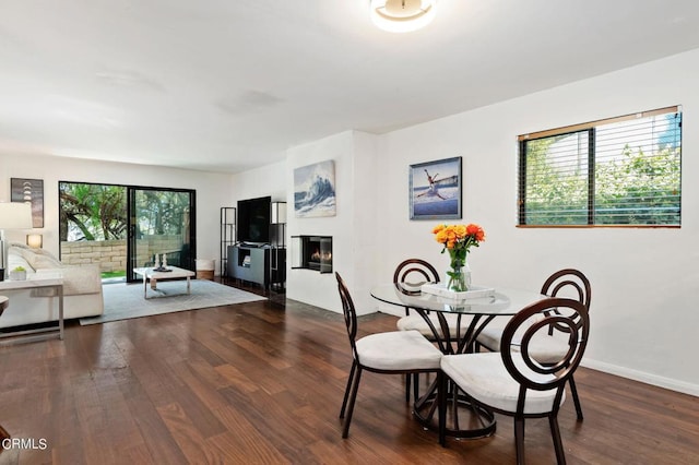 dining room with plenty of natural light and dark hardwood / wood-style flooring