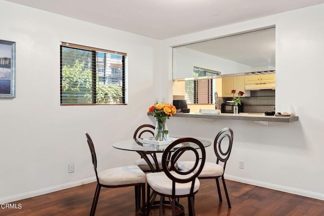 dining area with dark hardwood / wood-style flooring