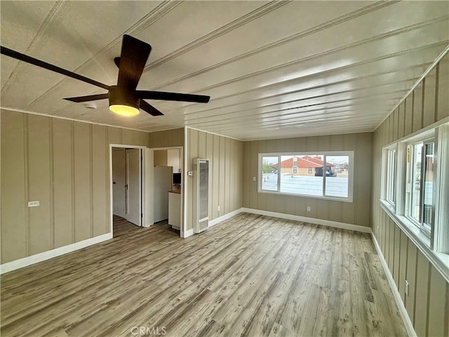 unfurnished living room with ceiling fan and light hardwood / wood-style flooring