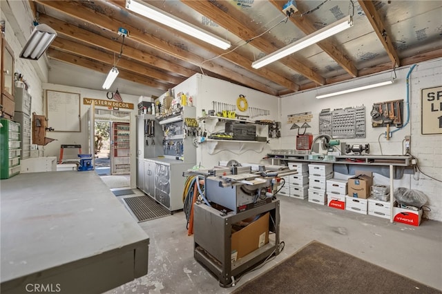 misc room featuring a workshop area and concrete flooring