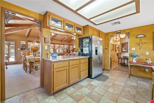 kitchen featuring decorative light fixtures, stainless steel refrigerator with ice dispenser, lofted ceiling with beams, wooden ceiling, and light colored carpet