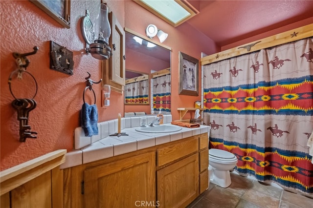 bathroom with vanity, toilet, and a shower with shower curtain