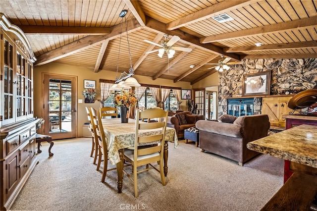 dining area with a wealth of natural light, vaulted ceiling with beams, ceiling fan, and light colored carpet