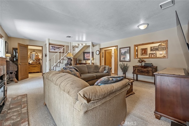 living room with light carpet and a textured ceiling