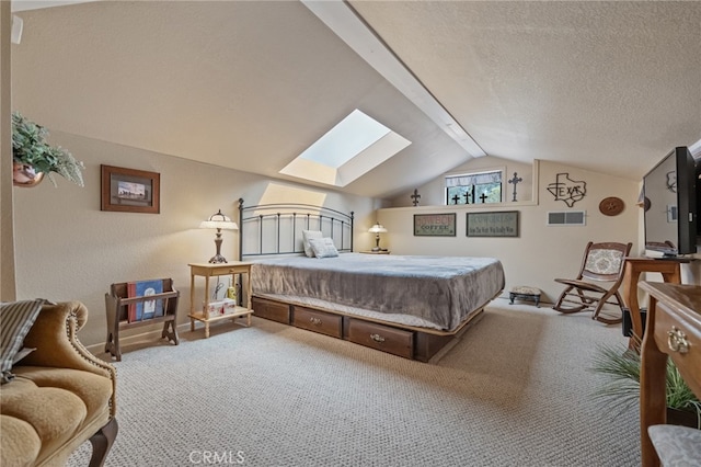 carpeted bedroom with vaulted ceiling with skylight and a textured ceiling