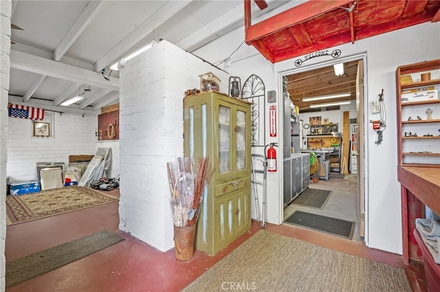 basement featuring brick wall and a workshop area