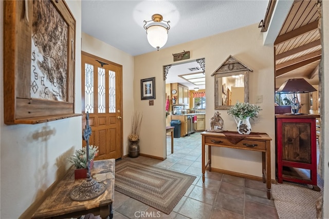 tiled foyer entrance with a wealth of natural light