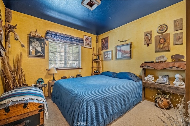 carpeted bedroom featuring a textured ceiling