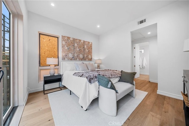 bedroom featuring access to exterior and light hardwood / wood-style flooring