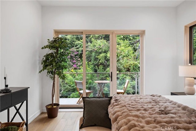 bedroom with light wood-type flooring and multiple windows