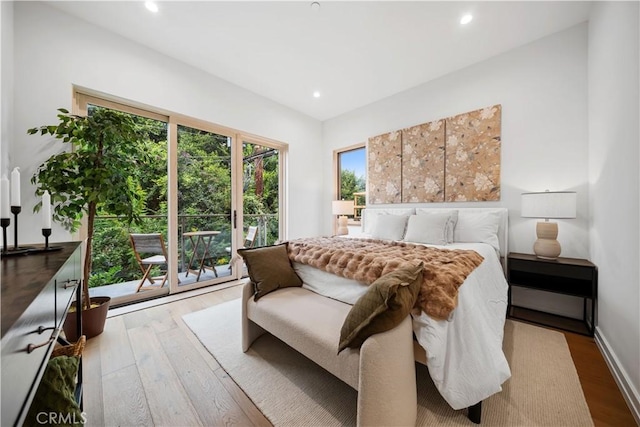 bedroom featuring access to exterior and hardwood / wood-style floors