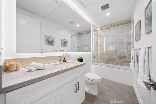 full bathroom featuring tile patterned floors, vanity, toilet, and combined bath / shower with glass door