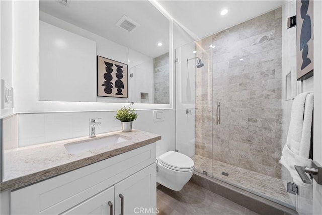 bathroom featuring vanity, toilet, and an enclosed shower