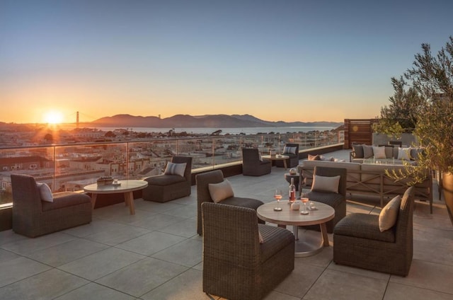 patio terrace at dusk with a mountain view and an outdoor living space