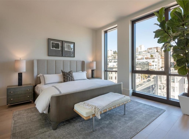 bedroom featuring light hardwood / wood-style floors and expansive windows