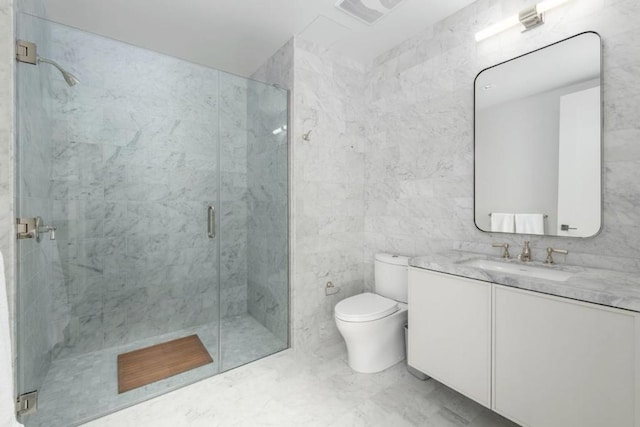 bathroom featuring toilet, tile walls, a shower with shower door, and vanity